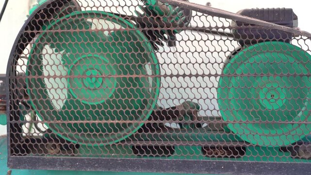 A diesel water pump engine equipped with small and large V-belts for its drive mechanism.                             