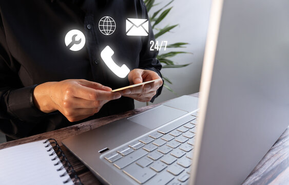 Remote worker manages digital communication tools using a card and laptop