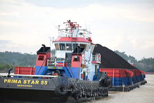Tugboat towing a pontoon.