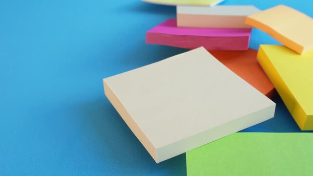 Vivid sticky notes in assorted colors on solid blue surface