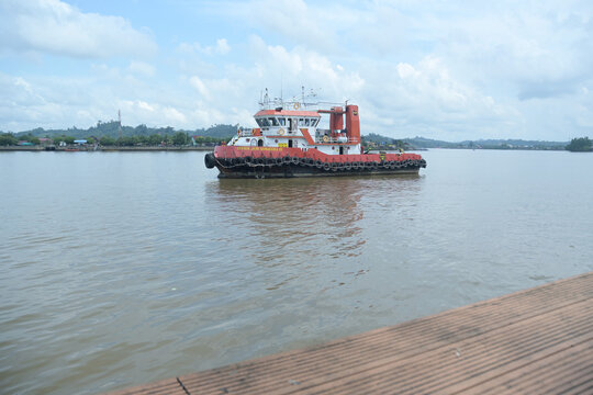 Tugboat towing a pontoon.