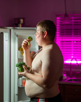 Belly shows excess weight. Late night belly signals overeating. Man holds belly after eating. Belly reflects unhealthy lifestyle.