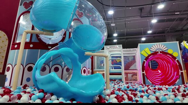Colorful Indoor Children Playground Featuring Spiral Slide and Ball Pit.