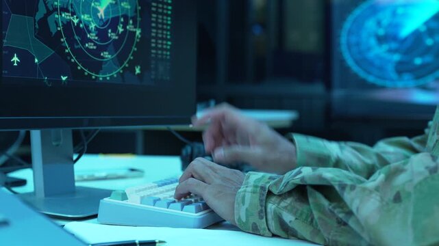 Team air traffic controller working on radar flight tracking screen in control room.