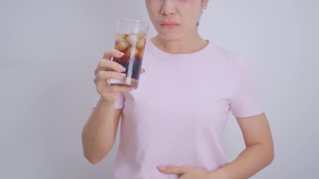Woman hand stop and refuse gesture to carbonated soft drink, feeling Abdominal pain after drinking soda water, bloating and gas in digestive system, stomach ache, Acid reflux, Heartburn and Gastritis