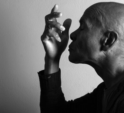 A serene portrait of a man praying with hands together in deep prayer that perfectly captures themes of faith, hope, mindfulness, and inner peace stock image stock photo