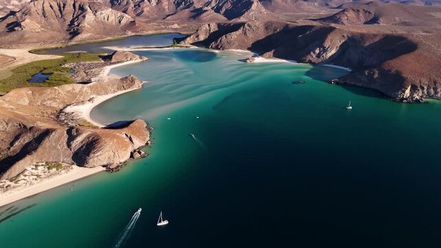Panoramic drone view of boats sailing across turquoise waters in Balandra beach La Paz Mexico