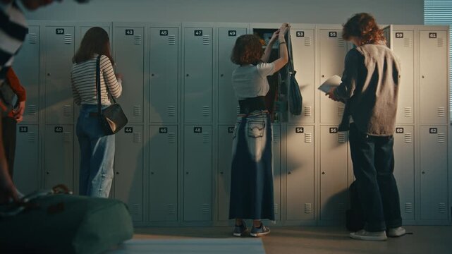 Diverse Teenage Classmates Hanging Out and Talking in School Locker Room or Hallway. Dressed in Casual Youth Fashion Boys and Girls Near Metal Lockers at Next Class. Authentic Generation Z Lifestyle.