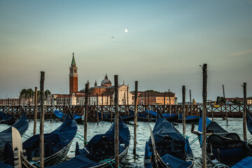 Moored Venetian Gondolas with San Giorgio Maggiore Across the Lagoon at Twilight in Venice, Italy © Pedro