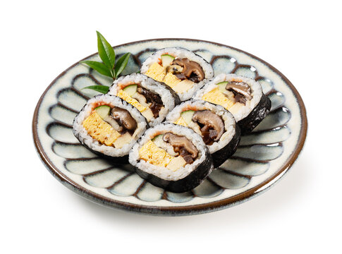 Japanese Futomaki Thick Sushi Rolls on Patterned Ceramic Plate Isolated on White Background