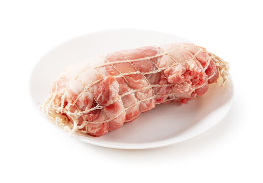 Raw Pork Shoulder Roast Tied in Meat Netting on White Plate Isolated on White Background