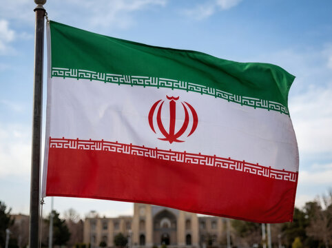 Iranian national flag waving in front of historic building