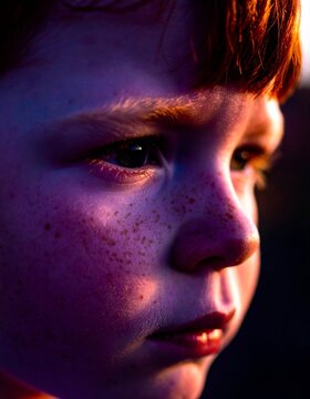 Dramatic Close Up Portrait Young Redhead Child Face With Freckles In Sunset Glow