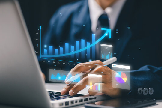Business analytics concept with professional using laptop and virtual growth chart, dashboards and graphs representing performance, strategy, financial planning and data driven decisions.