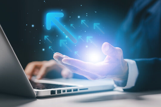 Business growth and digital transformation concept with professional using laptop and glowing upward arrows, symbolizing progress, innovation and future success in modern enterprise.
