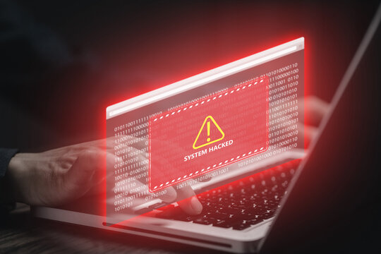 Cybersecurity breach concept with hacker using a laptop, red system hacked warning, binary code and digital alert interface representing online data security threats and cyber defense.