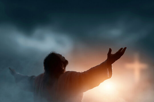 Silhouette of a figure with arms raised toward radiant light. Muted sky with soft clouds and distant glowing cross. Emotion conveys hope, surrender, or divine connection