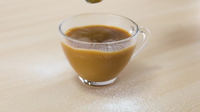 Stirring Hot Coffee with Dairy Alternative in Glass Mug