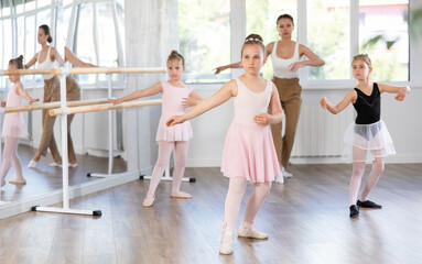 Ballet lesson for children - choreographer teaches girls ballet steps © JackF