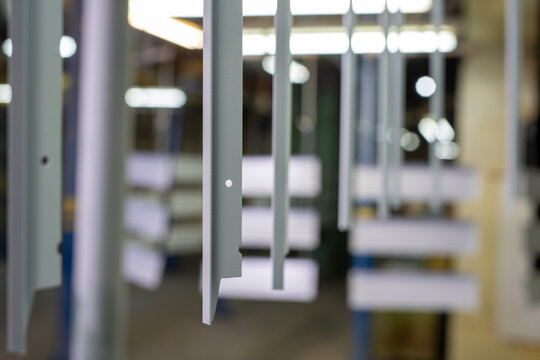 Industrial metal components in factory setting with shallow depth of field