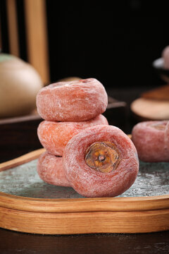 Dried persimmons with sugar frosting on wooden tray - Korean traditional sweet fruit snack