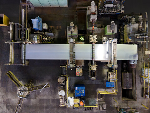 Overhead view of industrial factory floor with machinery and worker