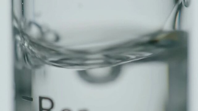 Extreme Macro Close-Up Of A Tiny Air Bubble Rising Through Water Showcasing Fluid Dynamics And Surface Tension