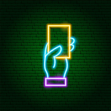 Hand Holding Yellow Card Neon Sign. Glowing Icon. Vector Illustration of Arbiter Soccer and Football Referree Concept Object.