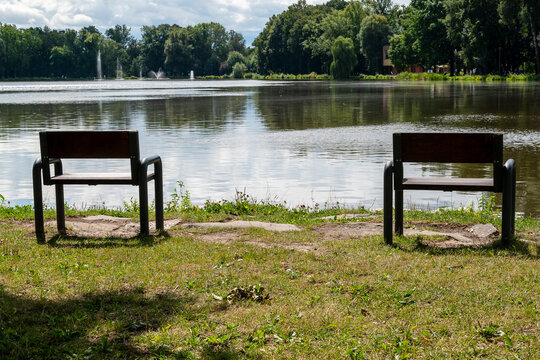 two benches overlooking the Nowa Huta Pond in summer