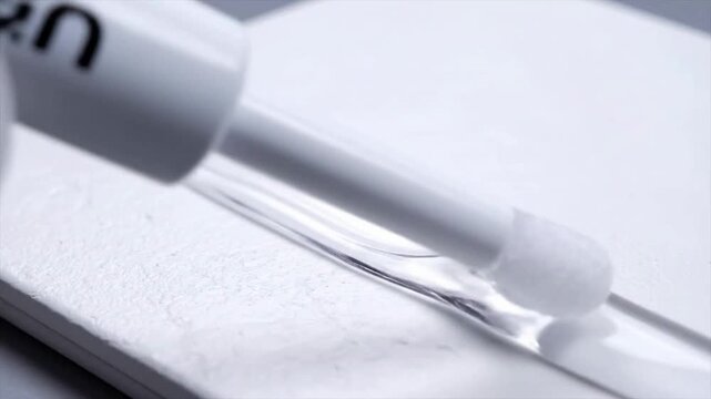 Macro Shot of a Sterile Applicator Wand Drawing a Smooth Line on a Clean Solid Background for Healthcare and Cosmetic Applications