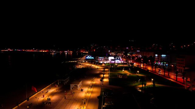 Aerial night view of Tangier&rsquo;s illuminated waterfront promenade, with seaside roads, public spaces and city lights showcasing nightlife and coastal tourism in Northern Morocco.