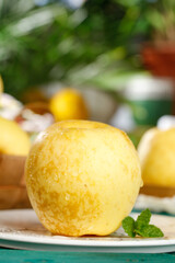 Fresh Golden Yellow Apples with Water Droplets and Mint Garnish on White Plate © KieuThi