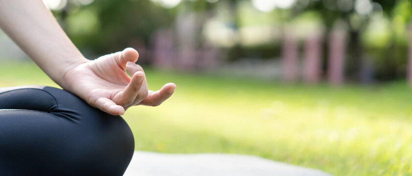 woman practicing meditate on the park. Asian woman doing exercises in morning. balance, recreation, relaxation, calm, good health, happy, relax, healthy lifestyle, reduce stress, peaceful, Attitude.
