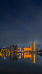 Fototapeta premium Wuhan night skyline with Hanxiu Theater reflected on the lake