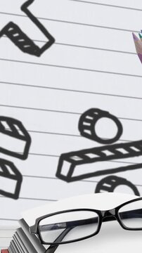 Multiple school equipment against mathematical symbols on white lined paper