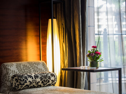 Modern Bedroom with City View, Elegant Seating and Warm Lighting