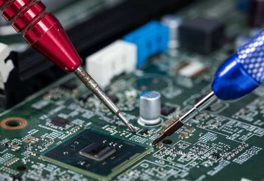 Precision electronic repair on circuit board with microchip