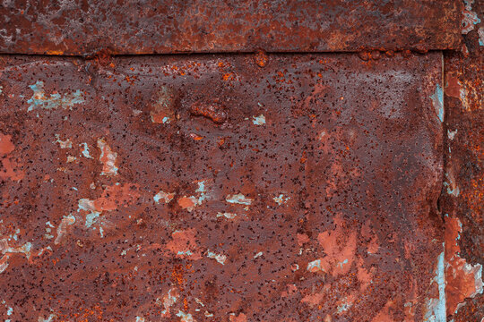 Rusted metal surface with visible welded seam and peeling paint. Industrial corrosion texture for welding, engineering and maintenance concepts. Ideal for construction, inspection, repair 