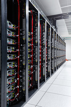 Server racks and network cables in a modern data center
