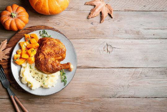 Autumn meal: roasted chicken quarter with pumpkin and mashed potato