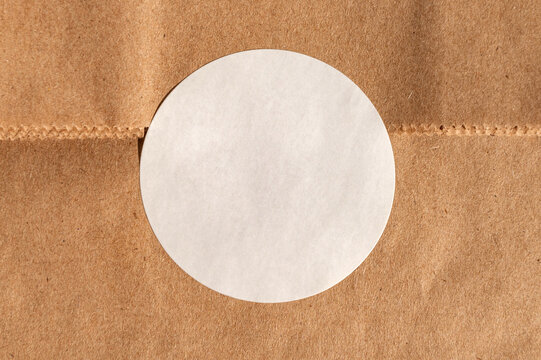 Blank white circle on brown kraft paper background texture