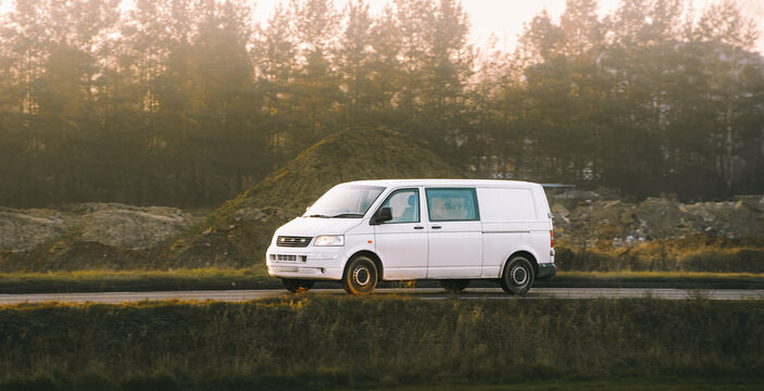 Courier van driving near forest road
