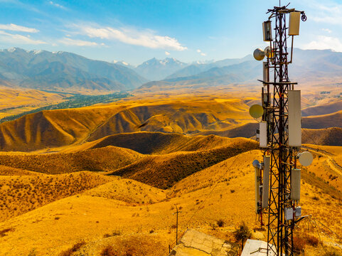 Telecommunications Tower Over Golden Hills and Mountains