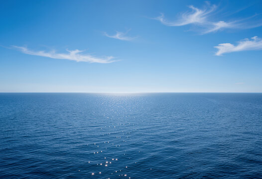 Ocean horizon over calm sea under blue sky