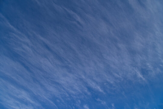 Wispy Cirrus Clouds Streaking Across a Clear Blue Sky