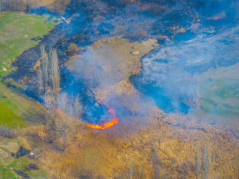Aerial View of Grass Fire in Kyrgyzstan with Smoke and Figures