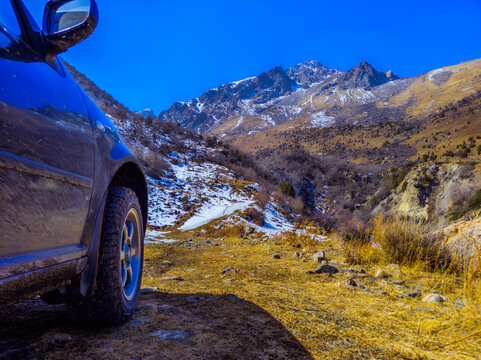 Car parked on a mountain road in Kyrgyzstan