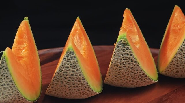 Sliced melon on black background.