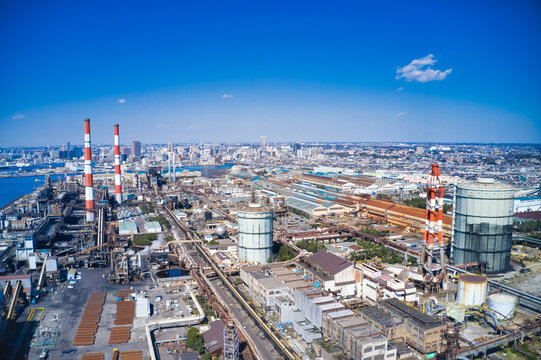 Aerial drone footage of an industrial zone. Factories, manufacturing, industry, smokestacks, energy, production, petrochemicals, refineries, iron and steel industry, electric power.