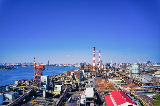 Aerial drone footage of an industrial zone. Factories, manufacturing, industry, smokestacks, energy, production, petrochemicals, refineries, iron and steel industry, electric power.